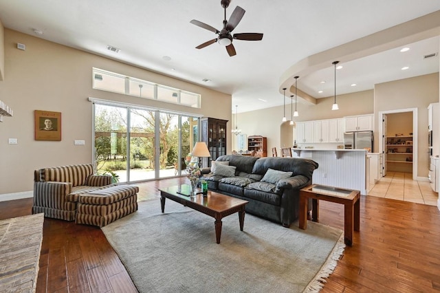 114 Hazelnut Ct, Driftwood, TX 78619 - living area with ceiling fan, light wood-style flooring, a towering ceiling, recessed lighting, and baseboards