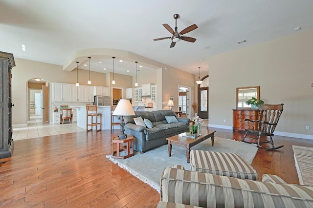114 Hazelnut Ct, Driftwood, TX 78619 - living area featuring arched walkways, ceiling fan, light wood finished floors, and recessed lighting