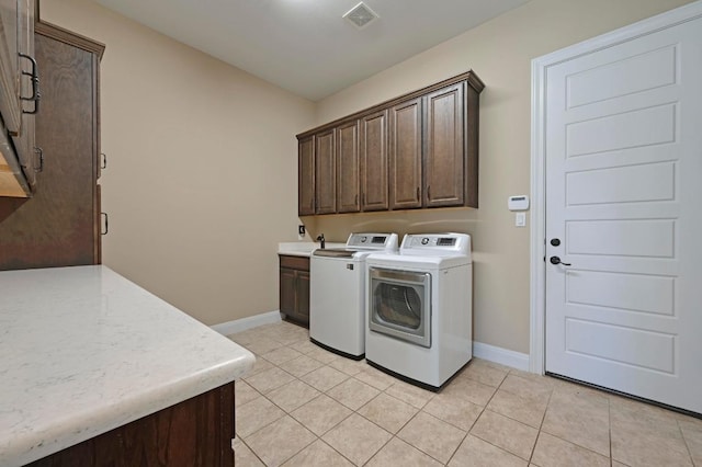 114 Hazelnut Ct, Driftwood, TX 78619 - laundry room featuring cabinet space, washer and clothes dryer, and light tile patterned floors