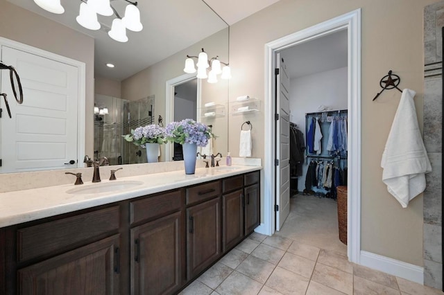 114 Hazelnut Ct, Driftwood, TX 78619 - full bathroom with a shower stall, double vanity, a chandelier, tile patterned floors, and a walk in closet