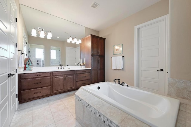 114 Hazelnut Ct, Driftwood, TX 78619 - bathroom with vanity, a garden tub, and tile patterned flooring