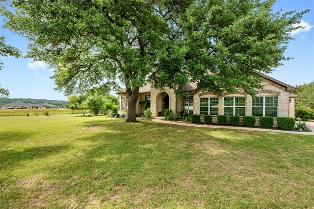 114 Hazelnut Ct, Driftwood, TX 78619 - view of front facade featuring a front yard and stone siding