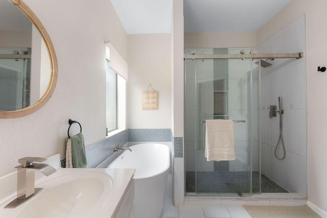 bathroom with a stall shower, a soaking tub, and vanity