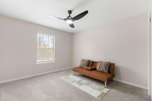 living area featuring carpet floors, a ceiling fan, and baseboards