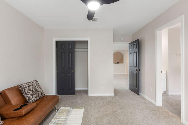 sitting room featuring ceiling fan, visible vents, baseboards, and carpet flooring