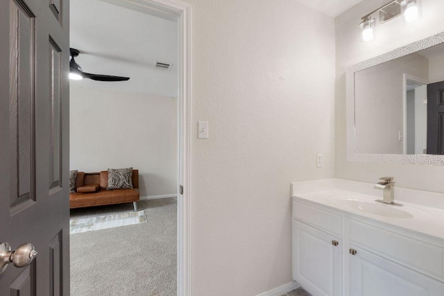 bathroom with visible vents, ceiling fan, vanity, and baseboards