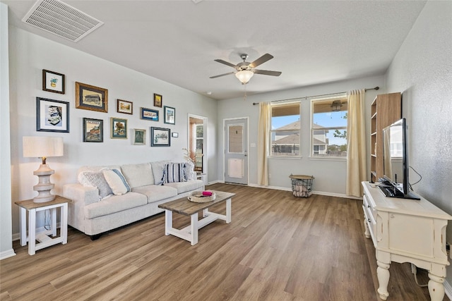 104 Canis St, Georgetown, TX 78628 - living area featuring wood finished floors, a ceiling fan, and baseboards