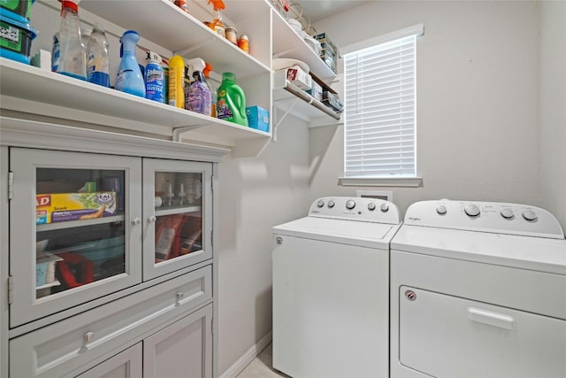 laundry room featuring baseboards and washing machine and clothes dryer