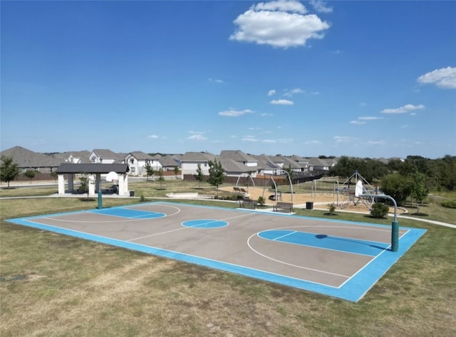 view of sport court featuring a residential view, playground community, community basketball court, and a lawn