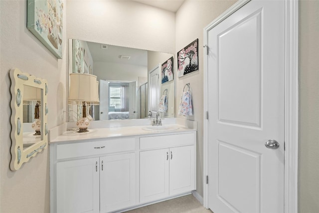 bathroom with vanity, visible vents, and ensuite bathroom