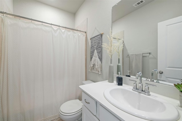 bathroom featuring toilet, a shower with curtain, visible vents, and vanity