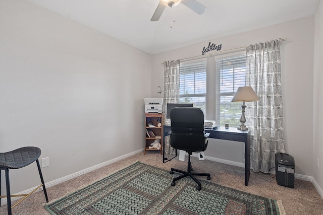 carpeted office space with ceiling fan and baseboards