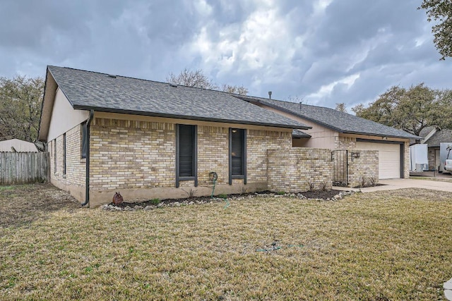 ranch-style house with a garage, concrete driveway, fence, a front yard, and brick siding