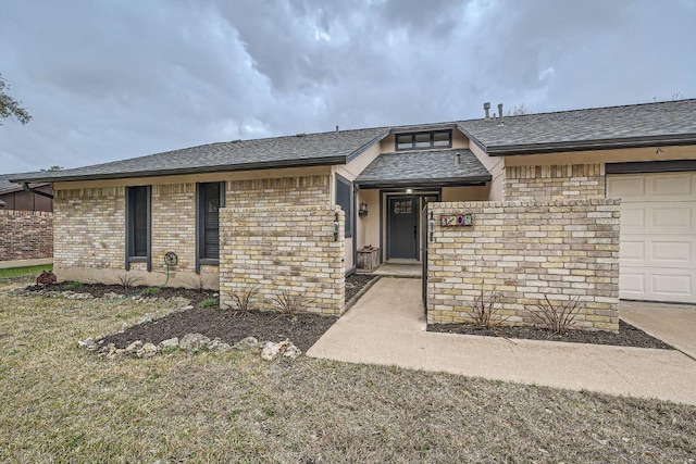 view of front of property with a garage, brick siding, and a shingled roof