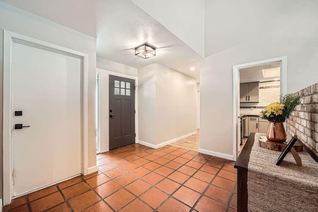 tiled foyer entrance with baseboards