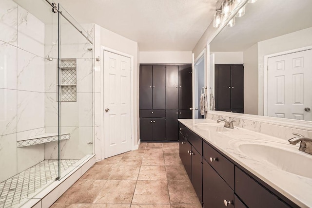 bathroom featuring a baseboard heating unit, double vanity, a stall shower, and a sink