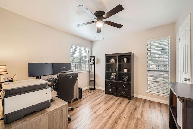 office with ceiling fan, baseboards, and wood finished floors