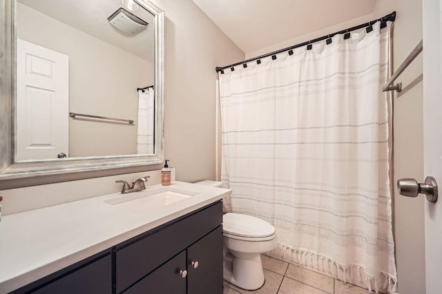 bathroom with curtained shower, vanity, toilet, and tile patterned floors