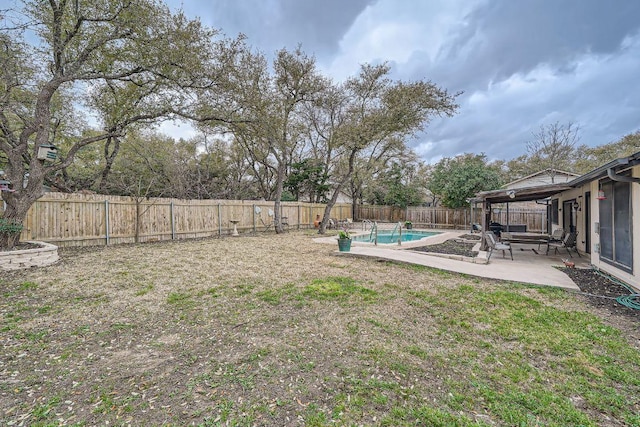 view of yard featuring a patio, a fenced backyard, and a fenced in pool