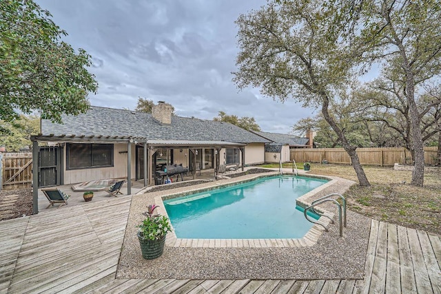 view of pool with a fenced backyard, a deck, and a fenced in pool