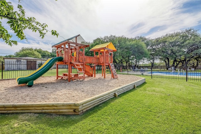 community playground featuring fence and a yard