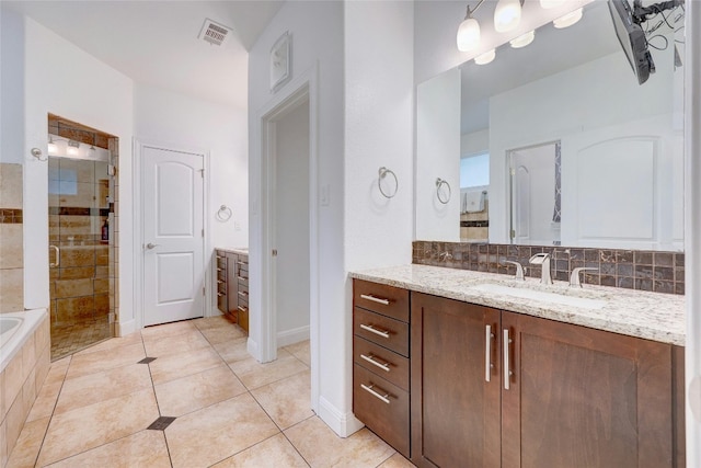 bathroom featuring backsplash, visible vents, a shower stall, and vanity