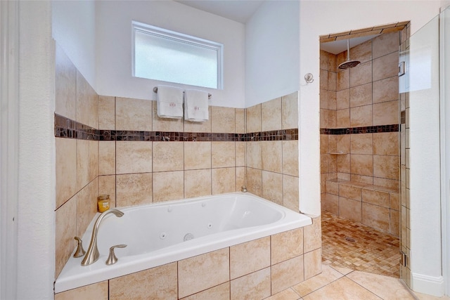 full bathroom with tiled shower, a jetted tub, and tile patterned flooring