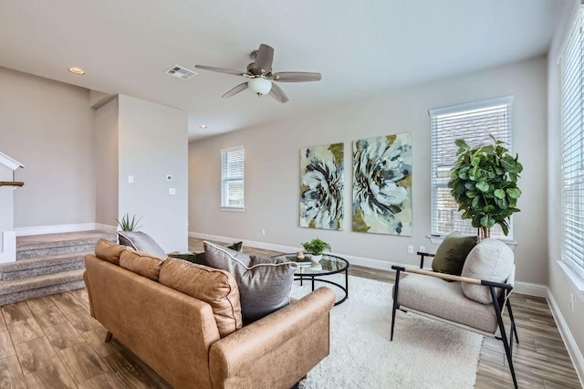 living area with a wealth of natural light, light wood-type flooring, and visible vents