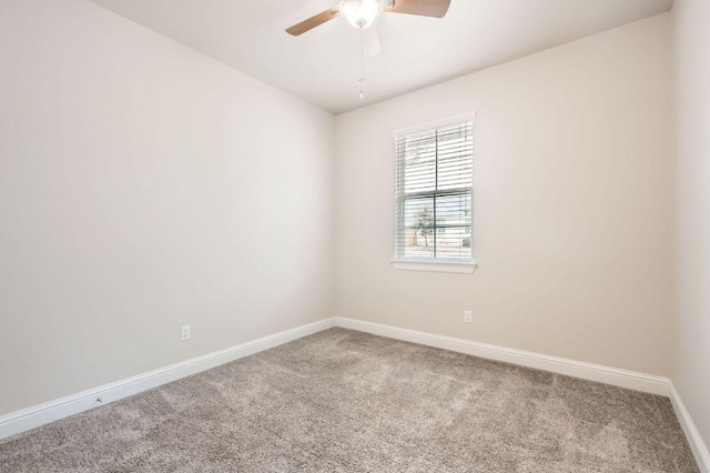 unfurnished room featuring carpet floors, a ceiling fan, and baseboards