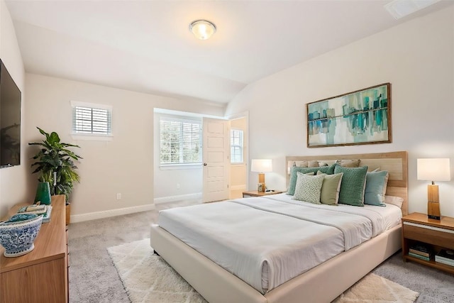 bedroom with lofted ceiling, light carpet, visible vents, and baseboards