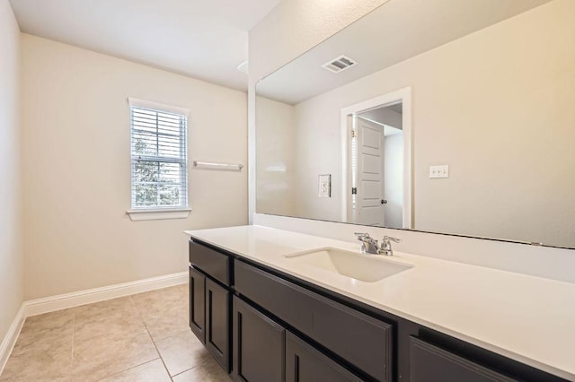 bathroom with vanity, tile patterned floors, visible vents, and baseboards