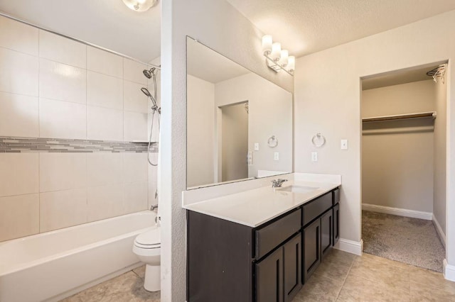 bathroom with toilet, vanity, shower / tub combination, tile patterned flooring, and baseboards