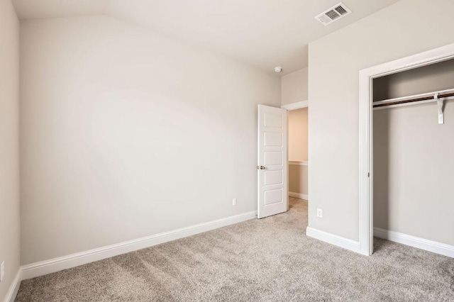 unfurnished bedroom featuring carpet, a closet, visible vents, and baseboards