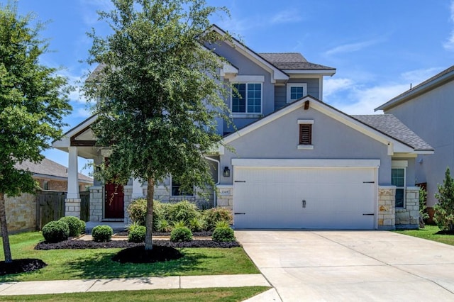 craftsman inspired home with stucco siding, fence, a garage, stone siding, and driveway