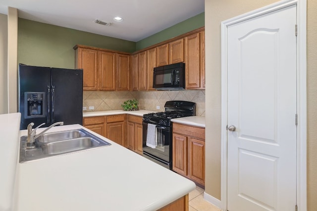 2000 Amur Dr, Austin, TX 78745 - kitchen featuring black appliances, decorative backsplash, recessed lighting, light countertops, and light tile patterned floors