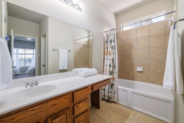 2000 Amur Dr, Austin, TX 78745 - ensuite bathroom featuring shower / bath combo with shower curtain, tile patterned flooring, and vanity
