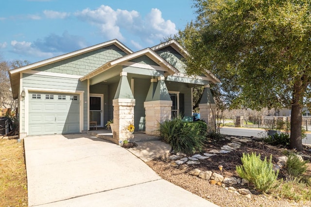 craftsman-style home featuring a garage, fence, and concrete driveway