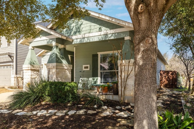 view of front of home with covered porch and a garage