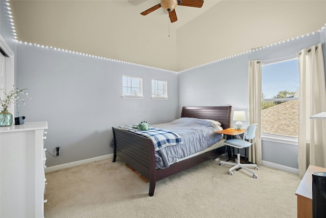 bedroom with baseboards, a ceiling fan, a towering ceiling, and light colored carpet