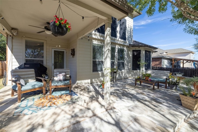 view of patio featuring fence, outdoor lounge area, and a ceiling fan