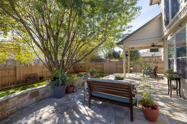 view of patio / terrace with an outdoor hangout area, a fenced backyard, and a ceiling fan