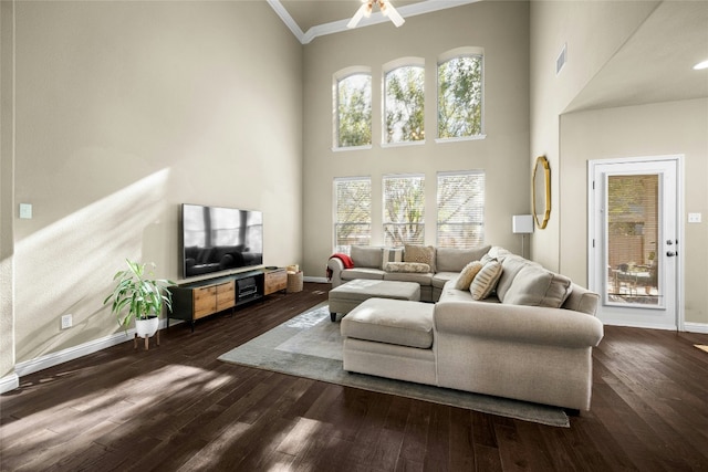 living room with visible vents, baseboards, and wood finished floors