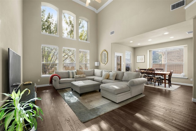 living area with dark wood-style flooring, visible vents, and baseboards