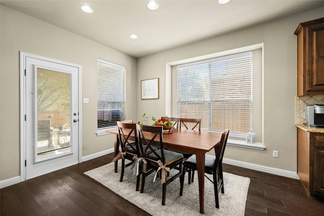 dining space with dark wood-type flooring, recessed lighting, and baseboards