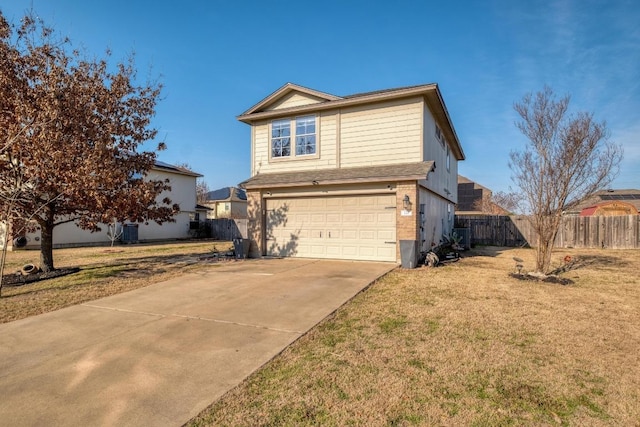 traditional-style house featuring concrete driveway, an attached garage, central AC unit, a front yard, and fence