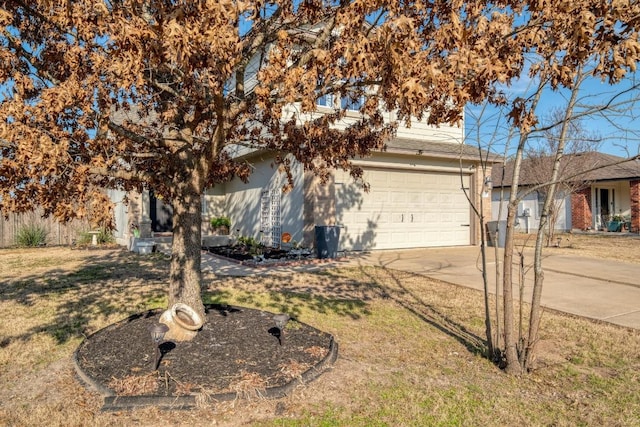 view of front of house with concrete driveway and a front yard