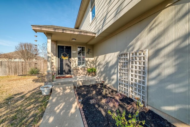 property entrance with a garage and fence