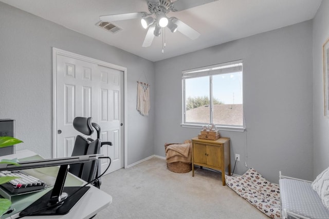 carpeted home office with visible vents and ceiling fan