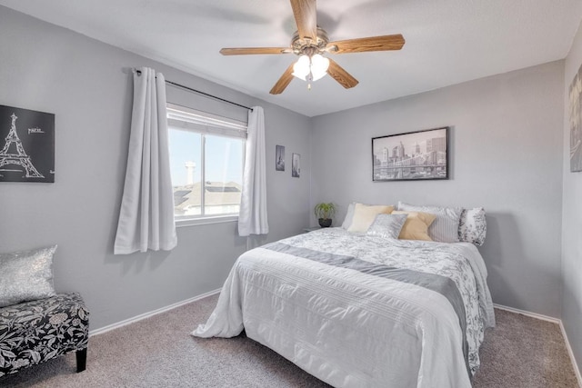 bedroom with a ceiling fan, baseboards, and carpet flooring