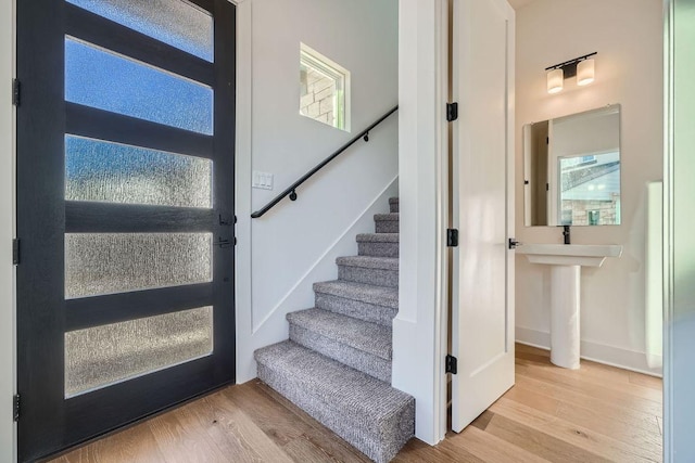 stairway with baseboards and wood finished floors